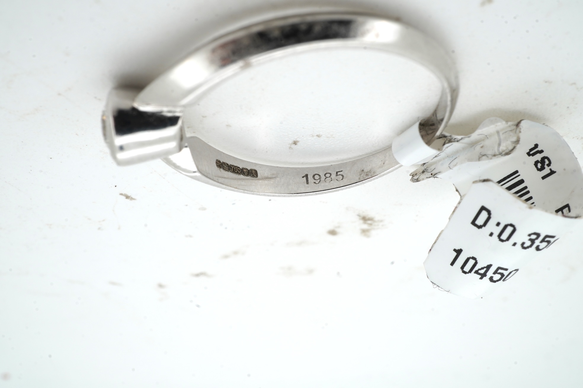 A diamond ring, collet-set with a brilliant-cut diamond weighing approximately 0.35 carats, mounted in 18ct white gold, size M, British hallmarks, gross weight approximately 2 grams